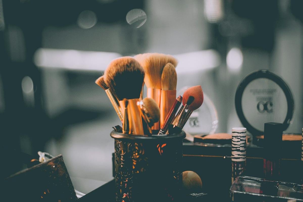 Makeup brushes arranged in a holder on a vanity