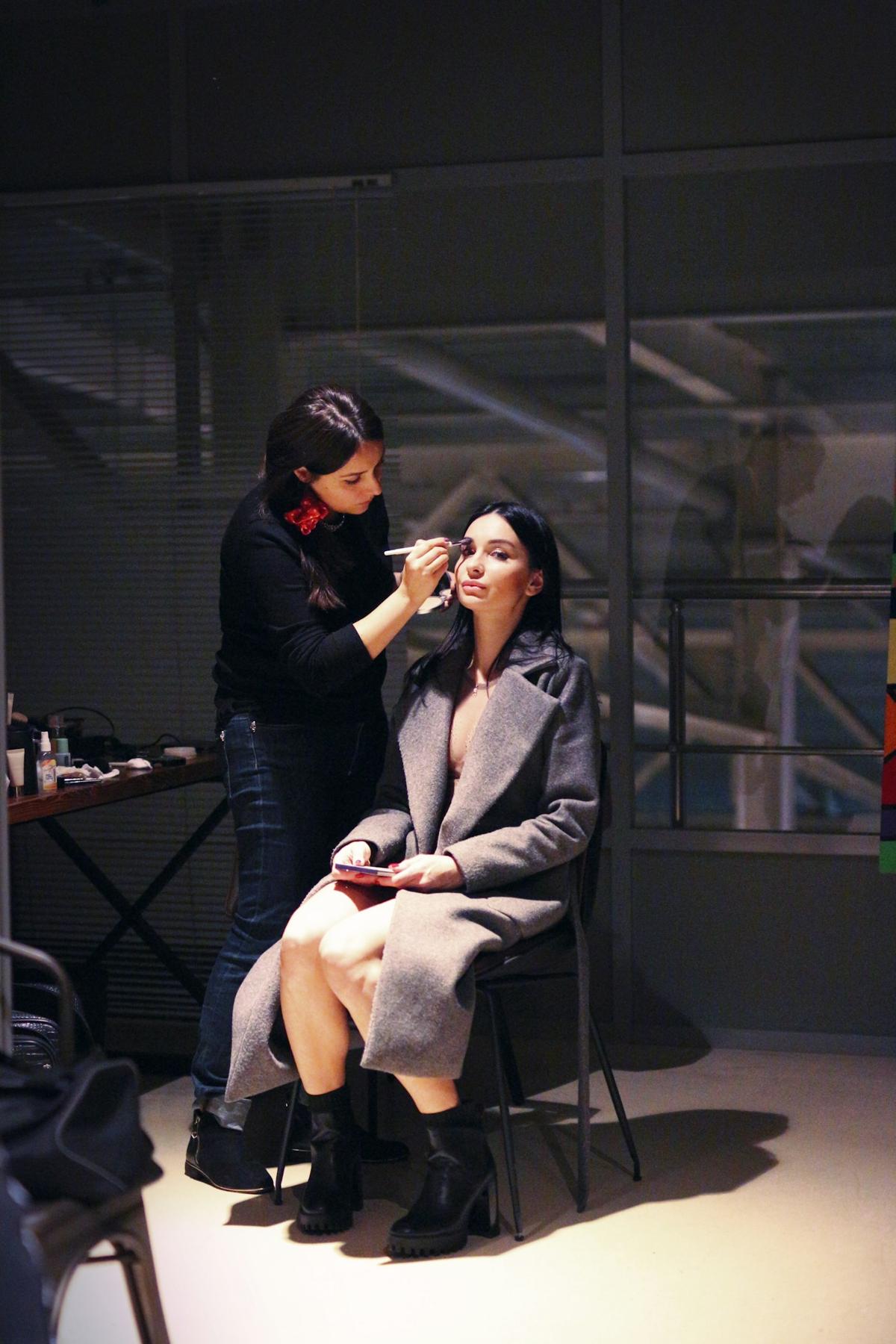 Makeup artist working on a client in the studio