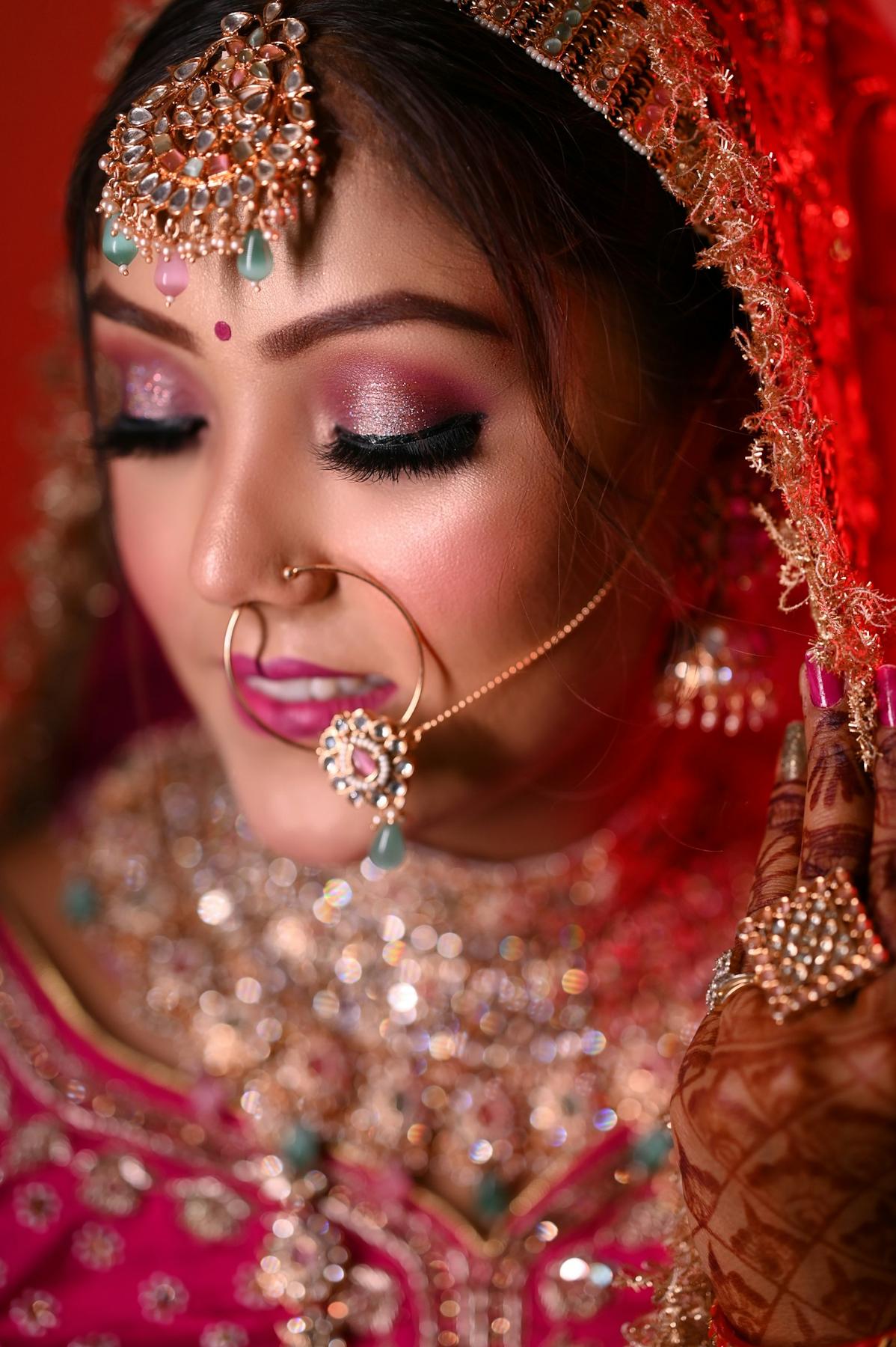 Close-up of bridal eye makeup with a nath and maang tikka