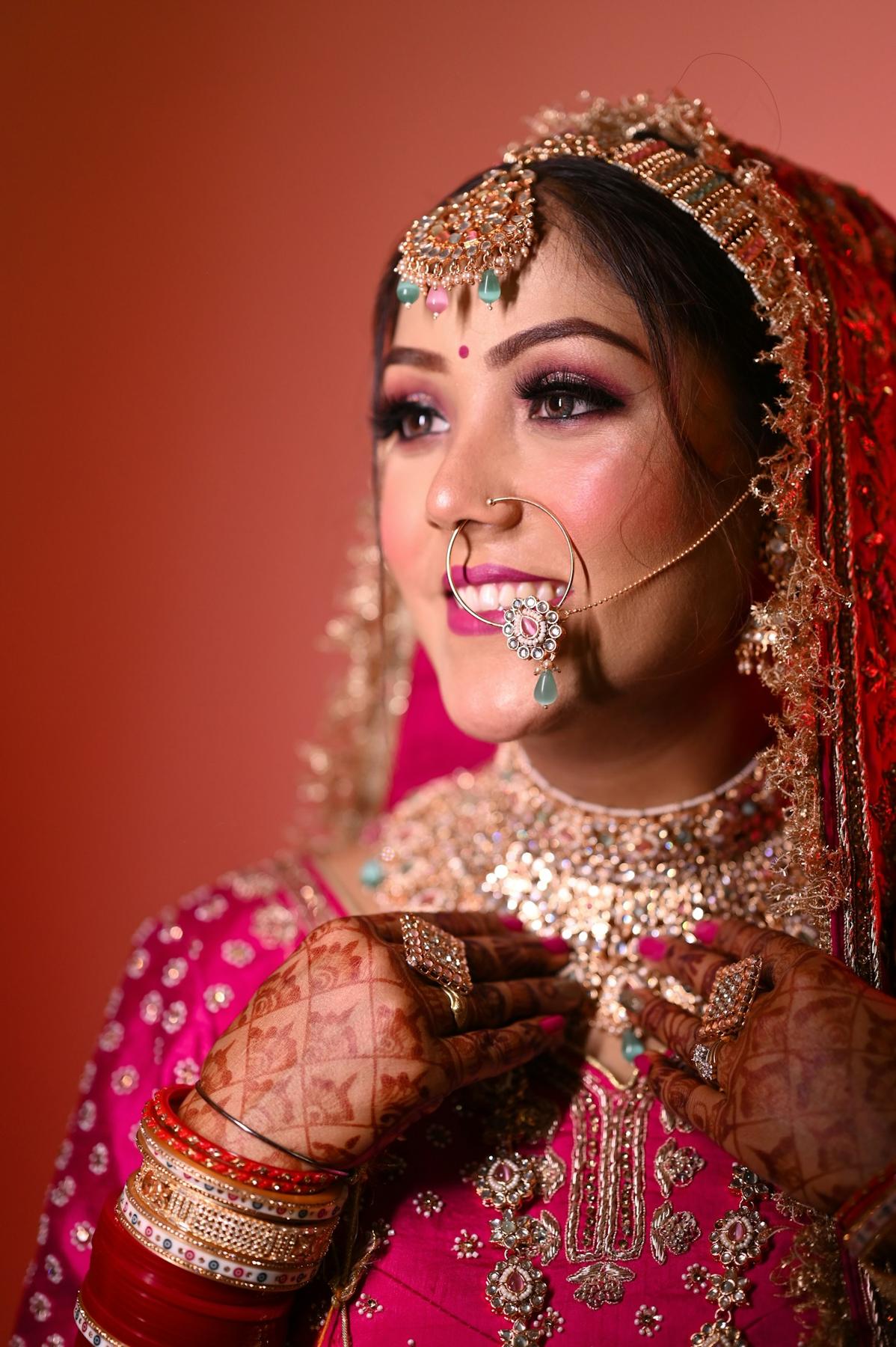 Bride with henna-covered hands and a soft glowing airbrush base