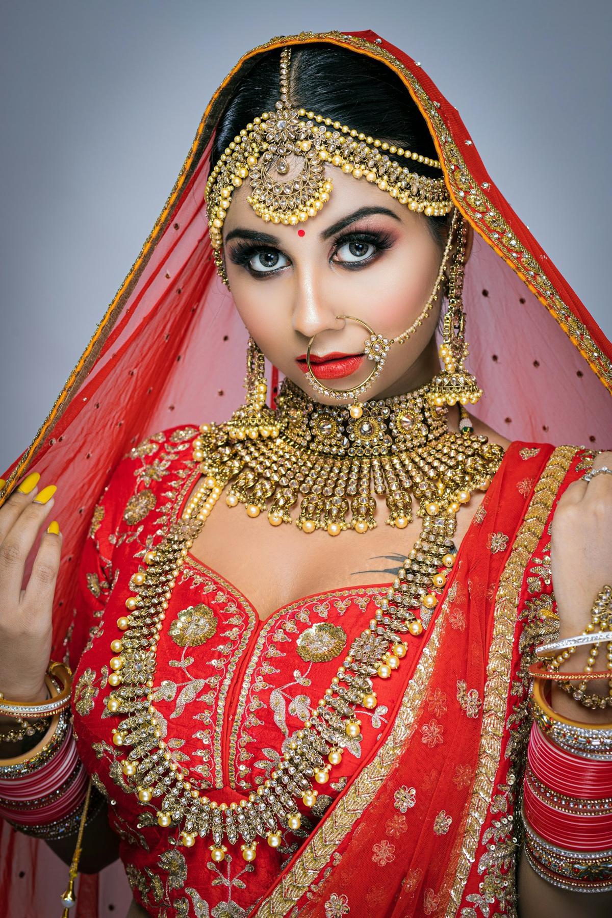 Close portrait of a bride with HD makeup, maang tikka and nath